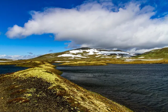 Snow-streaked ridge above a lake