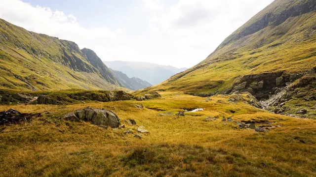 Green valley between steep hillsides